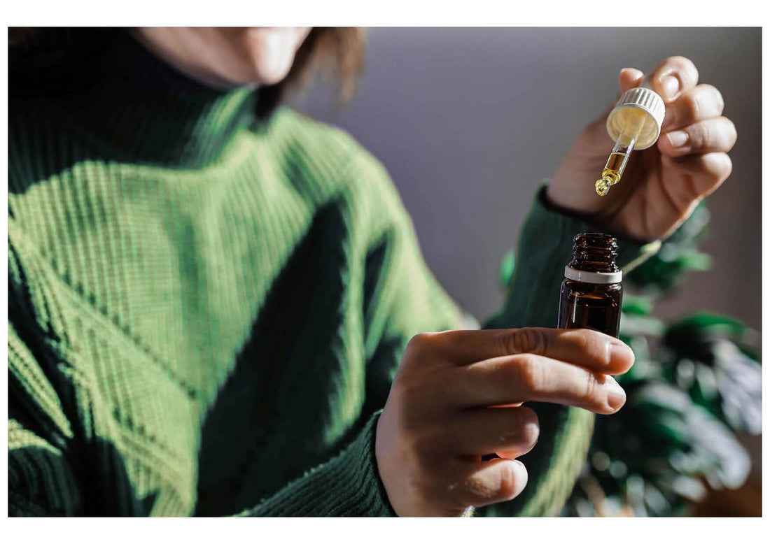 Women holding small bottle with dropper